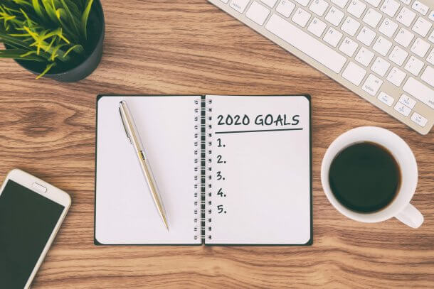 an open notebook with the words 2020 Goals written 